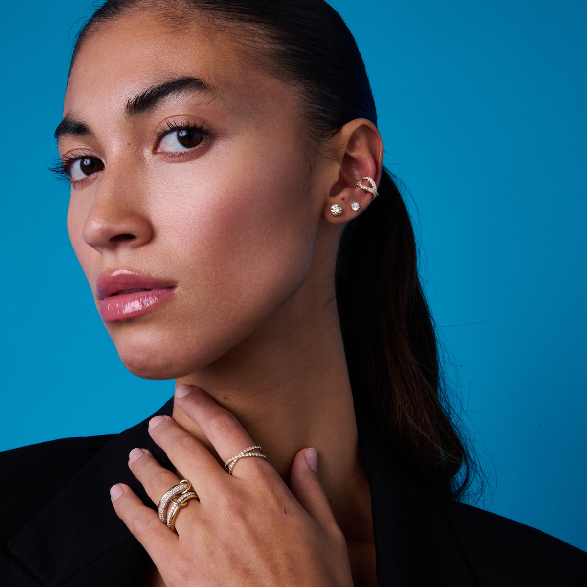 Close portrait showing a diamond ear cuff and studs