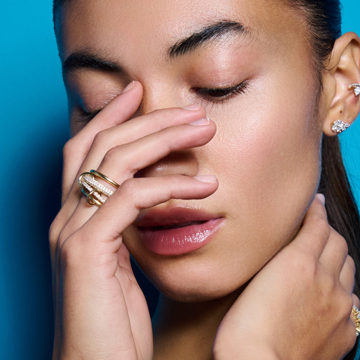 Multi band pavé diamond ring worn against E’LHAA blue